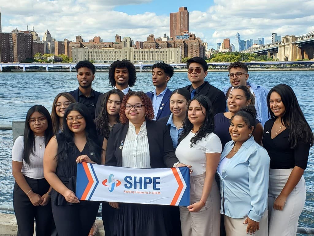 SHPE members with Leading Hispanics in STEM banner by the waterfront